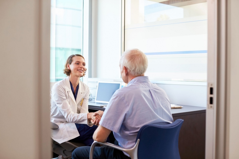 female doctor and elderly male patient in office